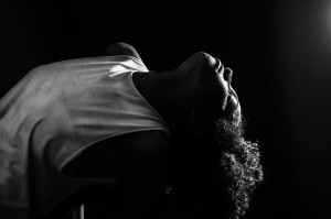 african american woman performing in darkness